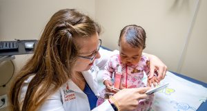 Doctor reading to pediatric patient